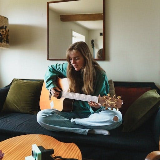 a woman playing guitar